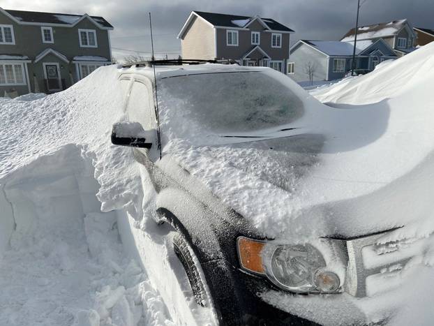 Pile of snow is pictured outside a house in St John