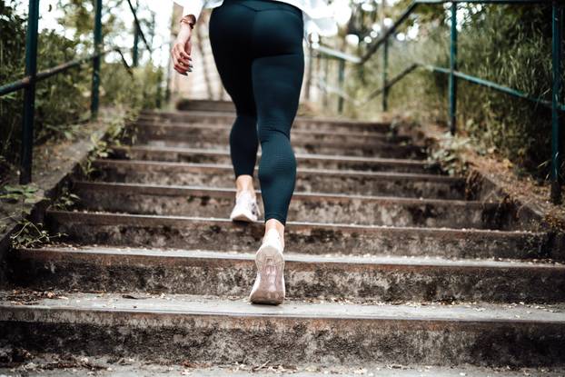 photo of a sport girl going up on stairs