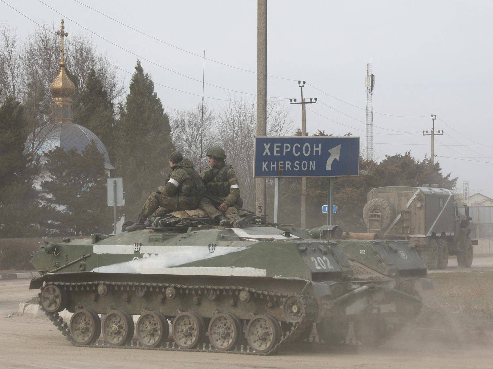 Russian Army military vehicle drives along a street in Armyansk