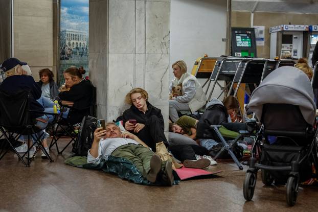 People take shelter inside a metro station during a Russian missile and drone attack in Kyiv