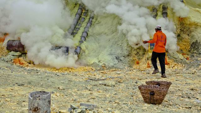 Sulfur workers at Kawa Ijen volcano in the sulfur mine, Kawa Ijen Plateau East Java Indonesia, Pacif