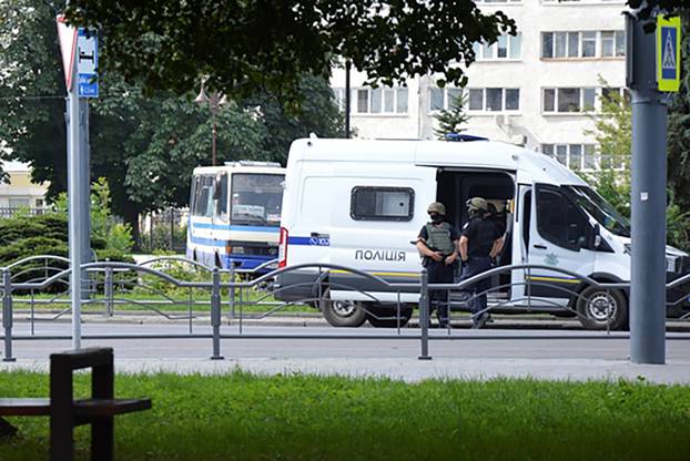Officers take part in a hostage rescue operation after an unidentified person seized a passenger bus in Lutsk