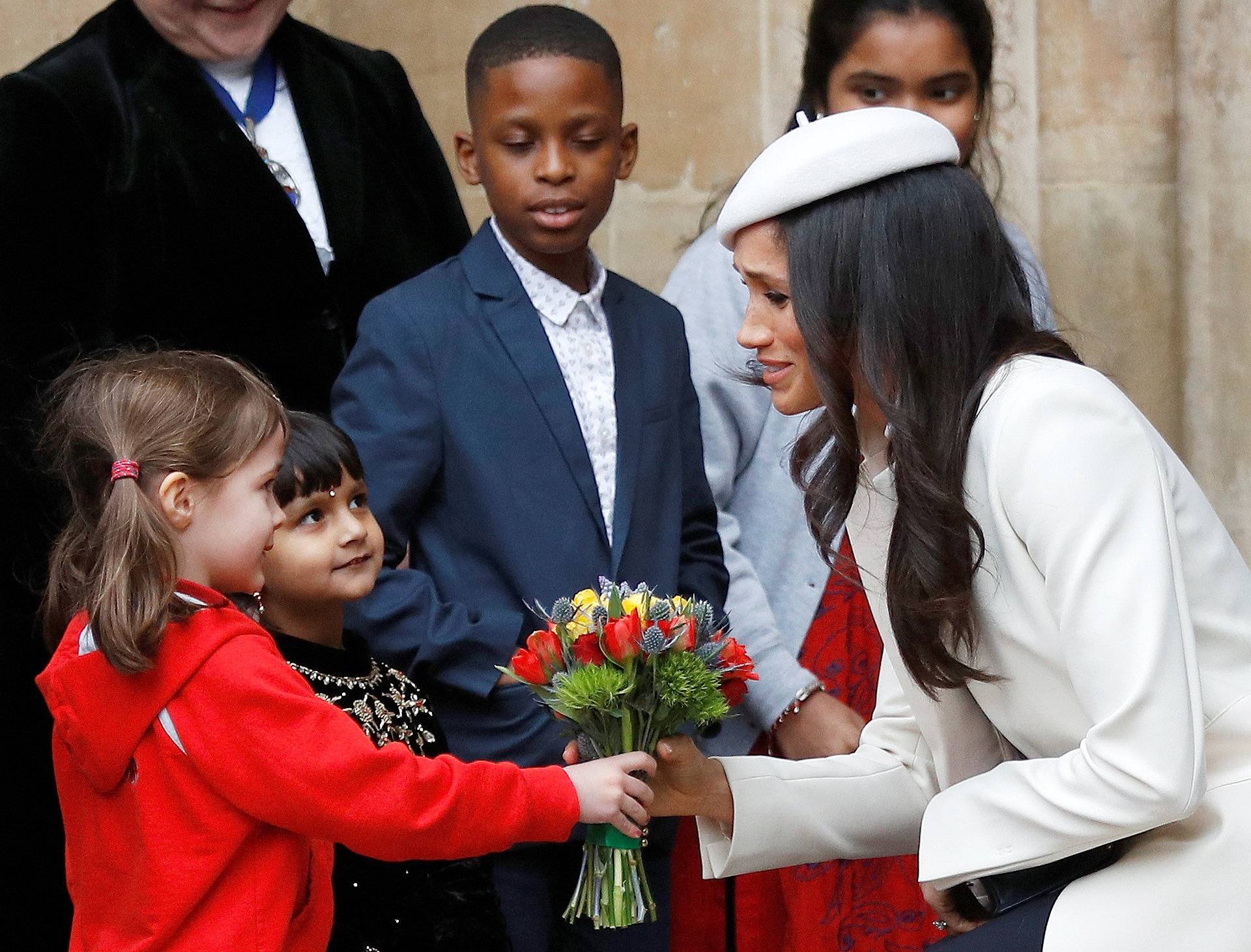 Britain's Prince Harry's fiancee Meghan Markle receives a bouquet of flowers after attending the Commonwealth Service at Westminster Abbey in London