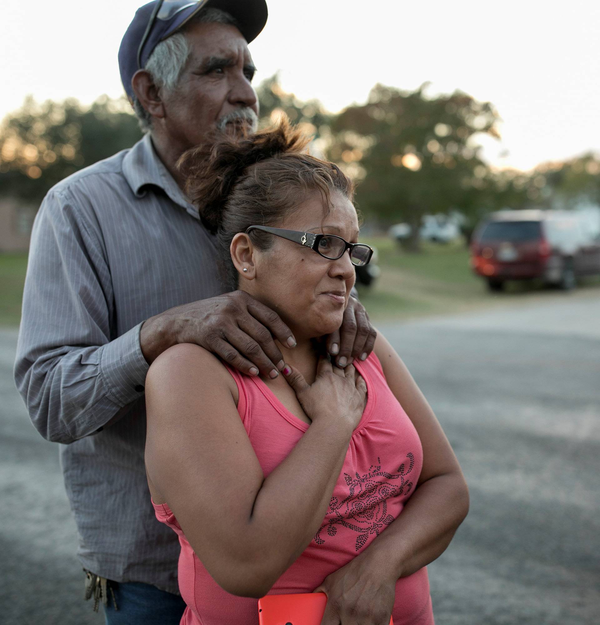 Enrique and Gabby Garcia watch as law enforcement officers investigate a mass shooting at the First Baptist Church in Sutherland Springs