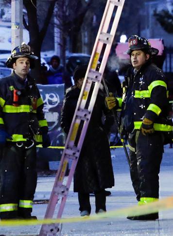 Fire Department of New York (FDNY) personnel work on the scene of an apartment fire in Bronx in New York