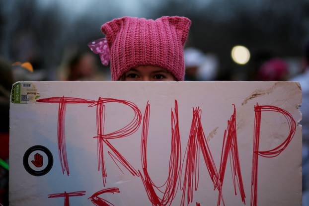 A woman wearing pink pussy protest hat poses for a photograph during the Women