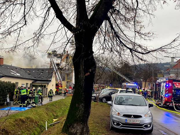 Rescue workers are seen at the site of an explosion of a house in Langenzersdorf