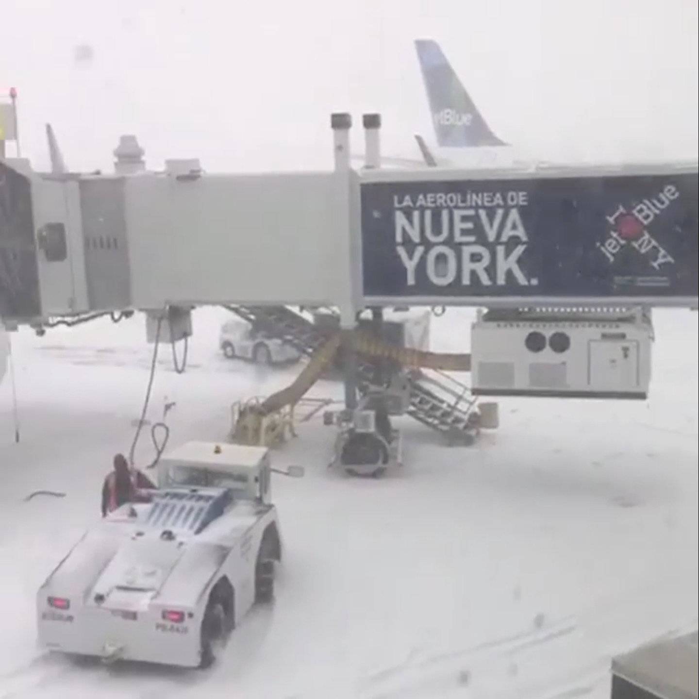 Staff work on the John F. Kennedy International Airport apron during a snow storm, in Queens, New York