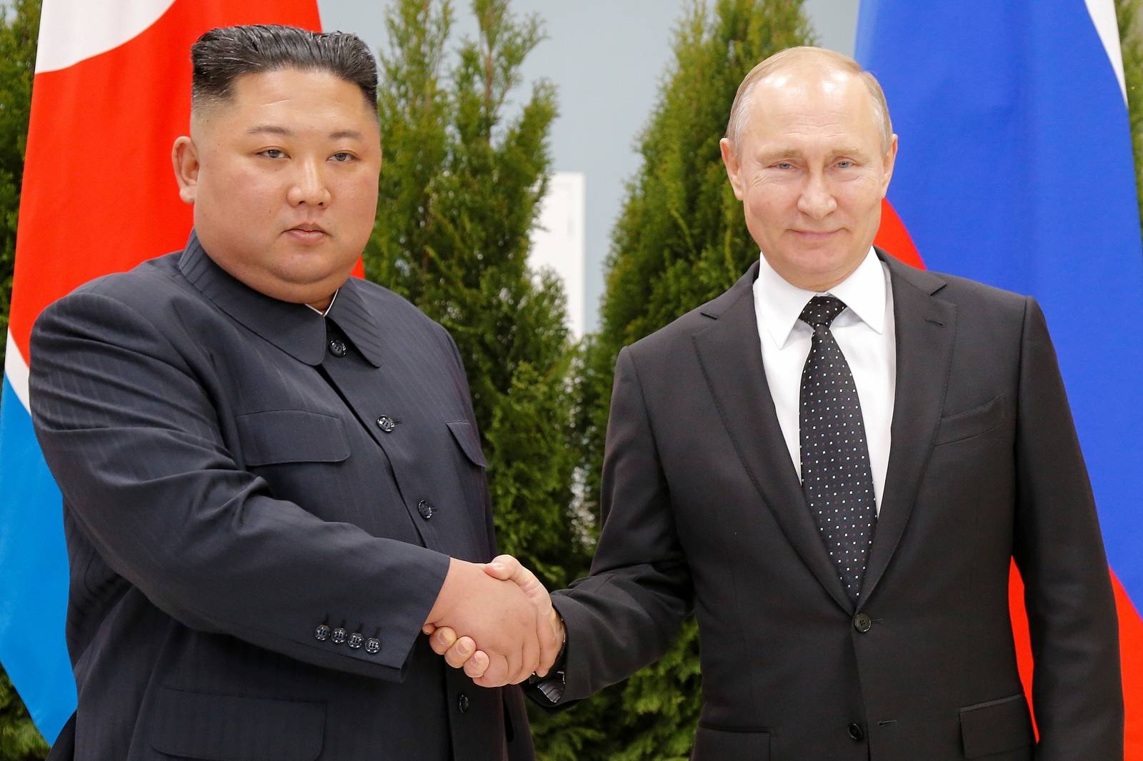 Russian President Vladimir Putin and North Korea's leader Kim Jong Un shake hands during their meeting in Vladivostok