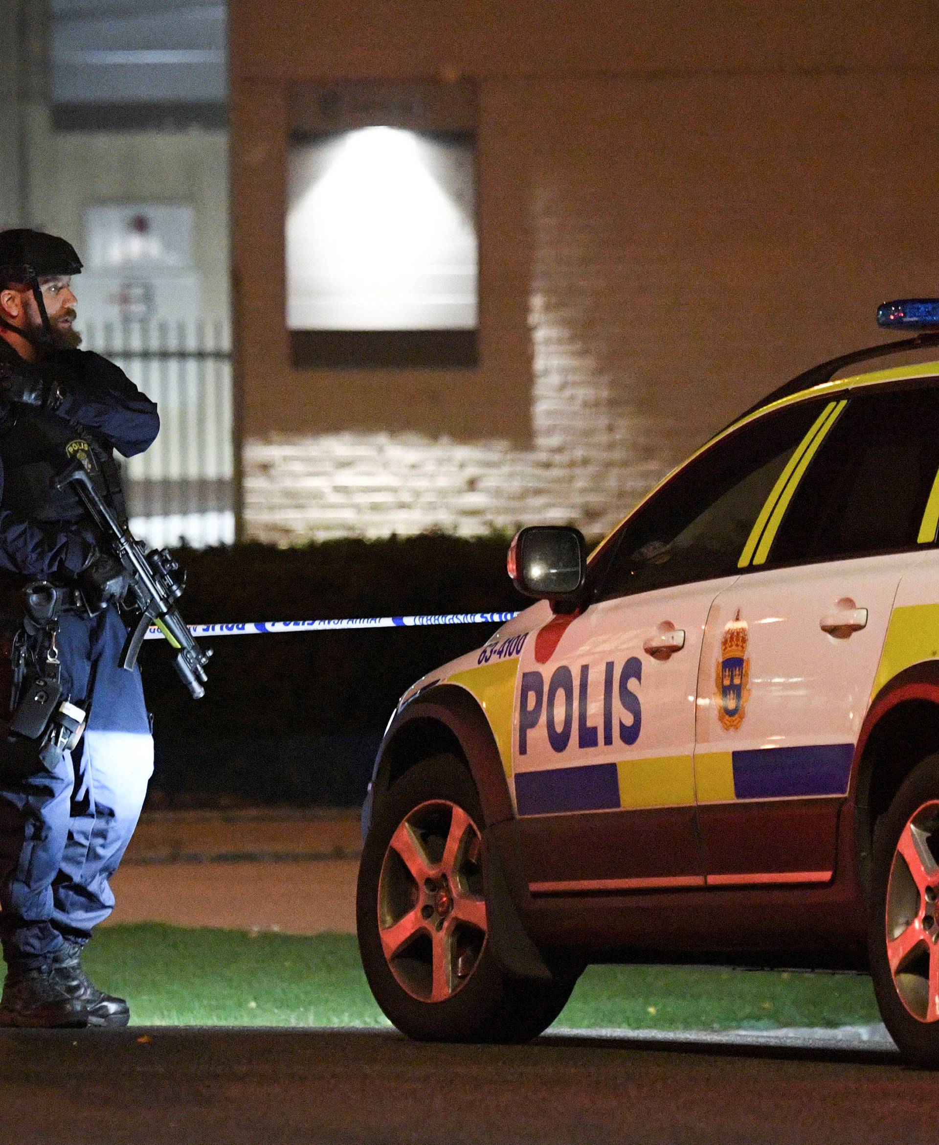 A police officer guards outside a cordoned area surrounding the police station in Helsingborg