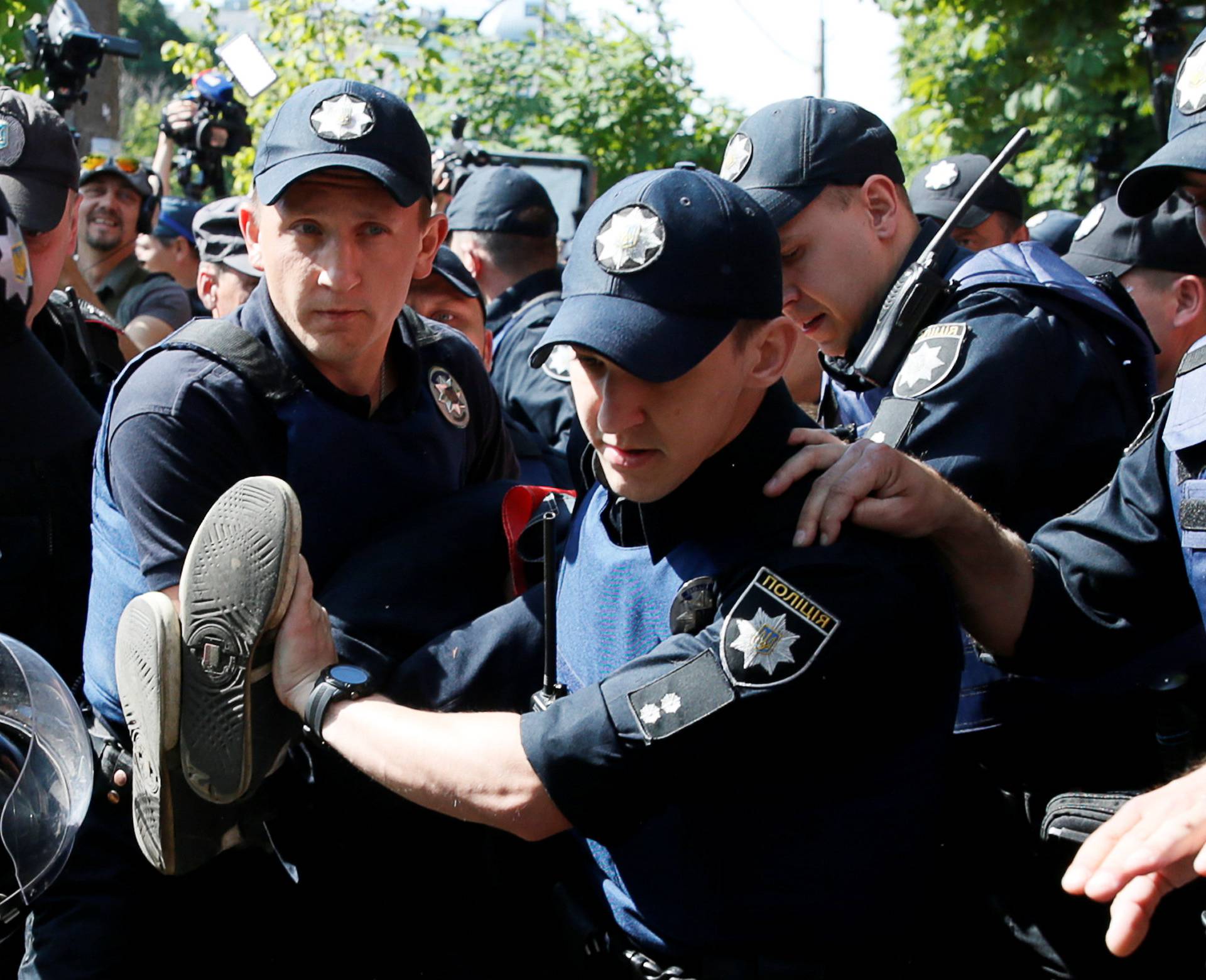 Policemen detain anti-gay protester during Equality March in Kiev