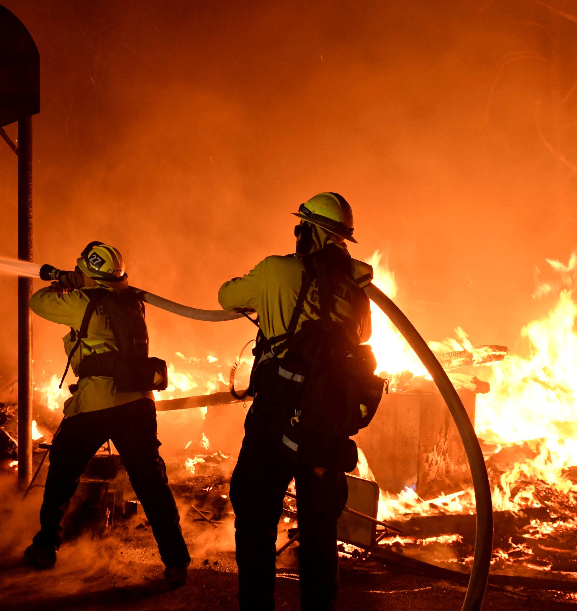 FILE PHOTO: Firefighters battle flames from a Santa Ana wind-driven brush fire called the Thomas Fire in Santa Paula California