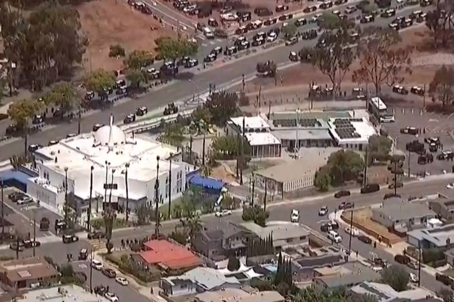 Police vehicles crowd nearby streets after an "active shooter situation" was reported at the Islamic Center in San Diego