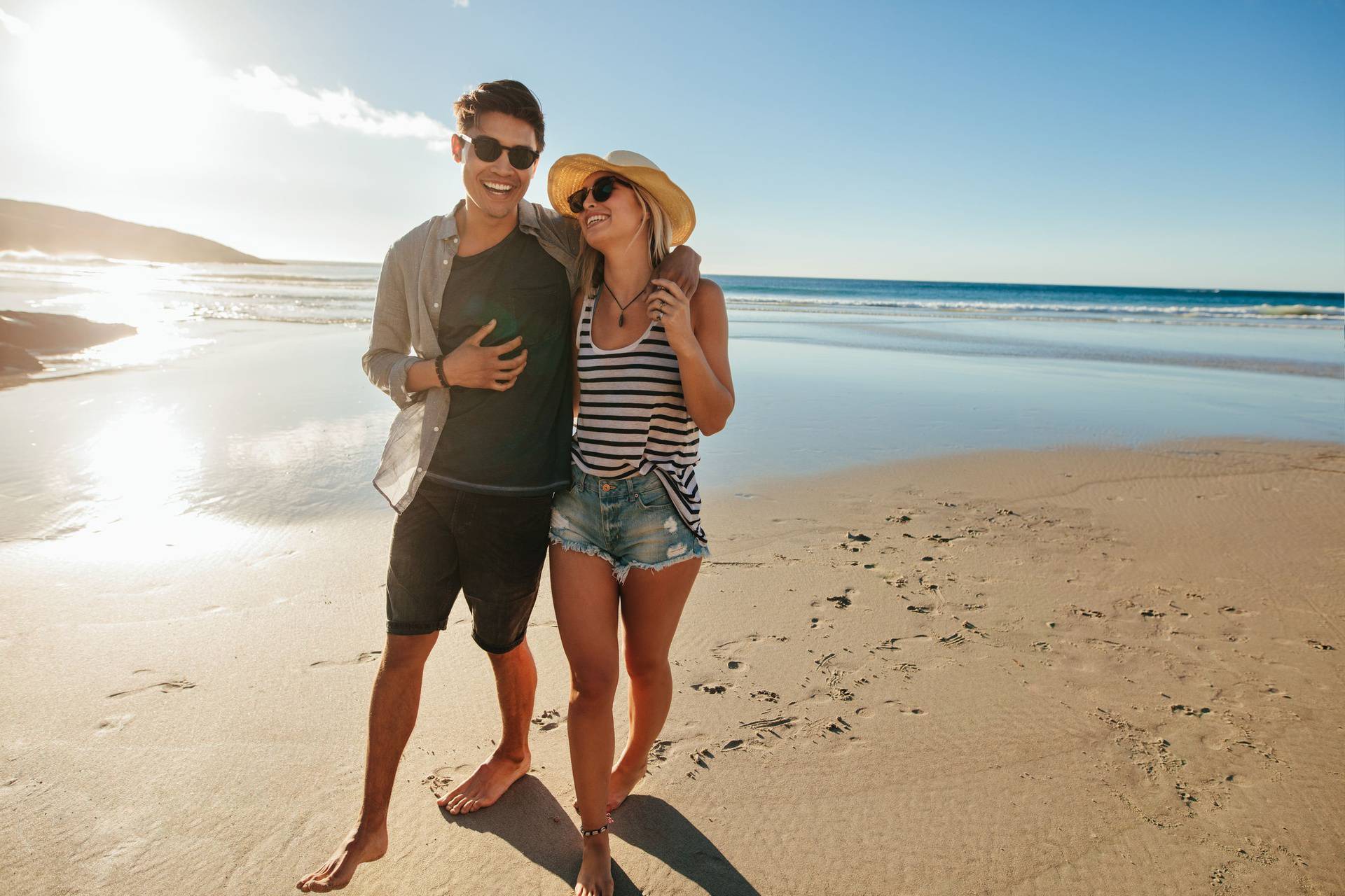 Romantic young couple walking on beach