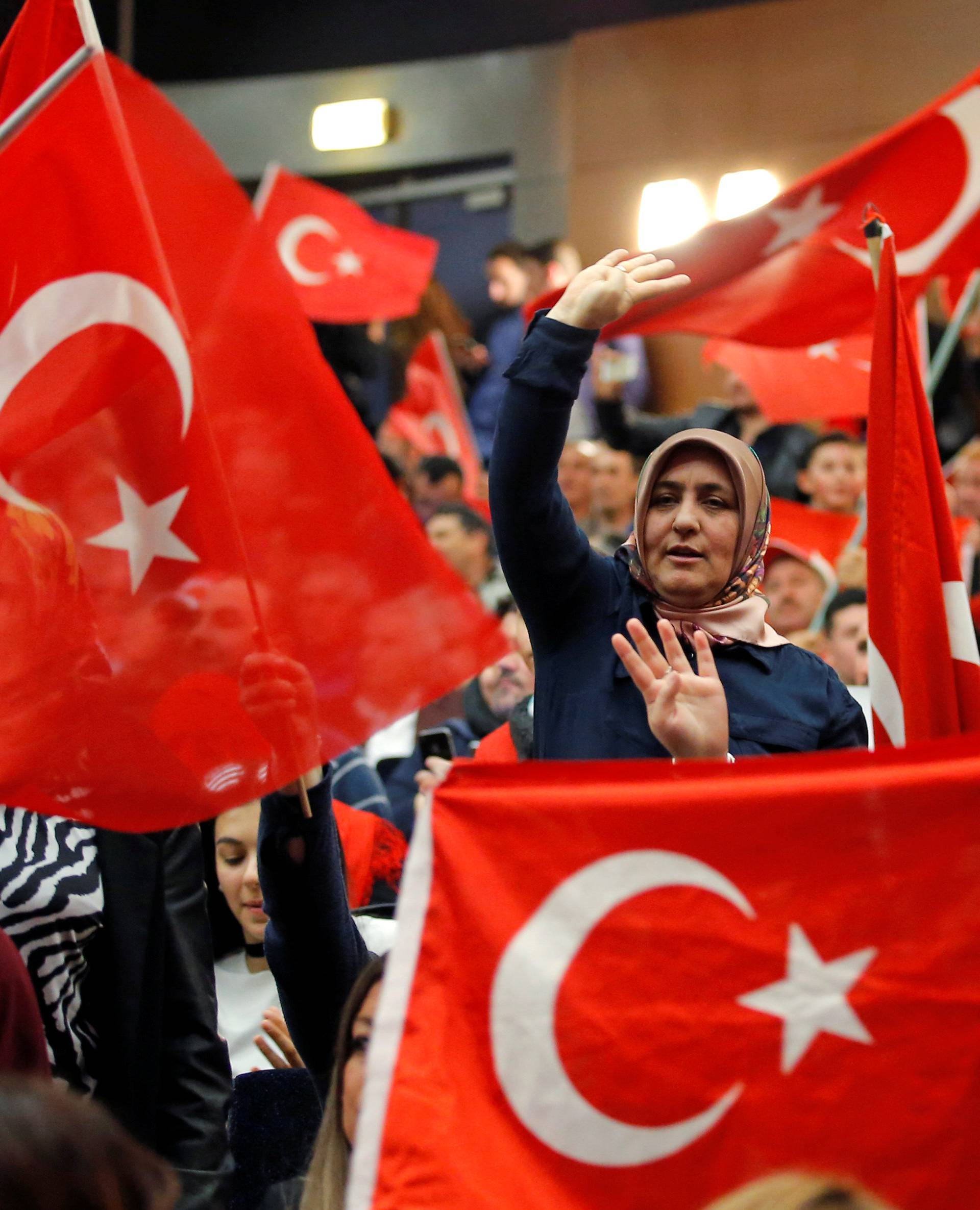 Supporters wave Turkish flags ahead of the start of a political rally on Turkey's upcoming referendum, in Metz