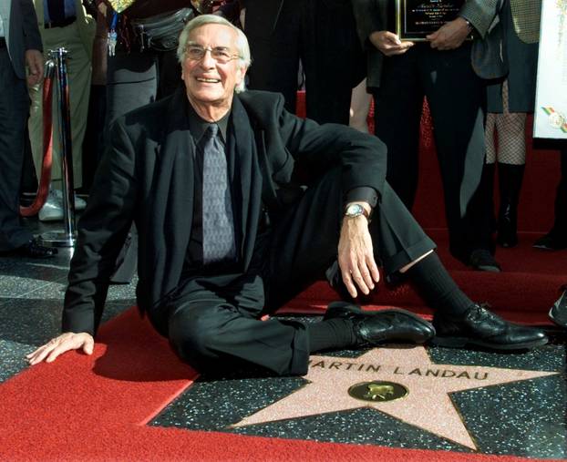 FILE PHOTO -  Academy award winning actor Martin Landau sits on his new star on the Hollywood Walk of Fame, as he poses for photographers during ceremonies to honor him, in Hollywood