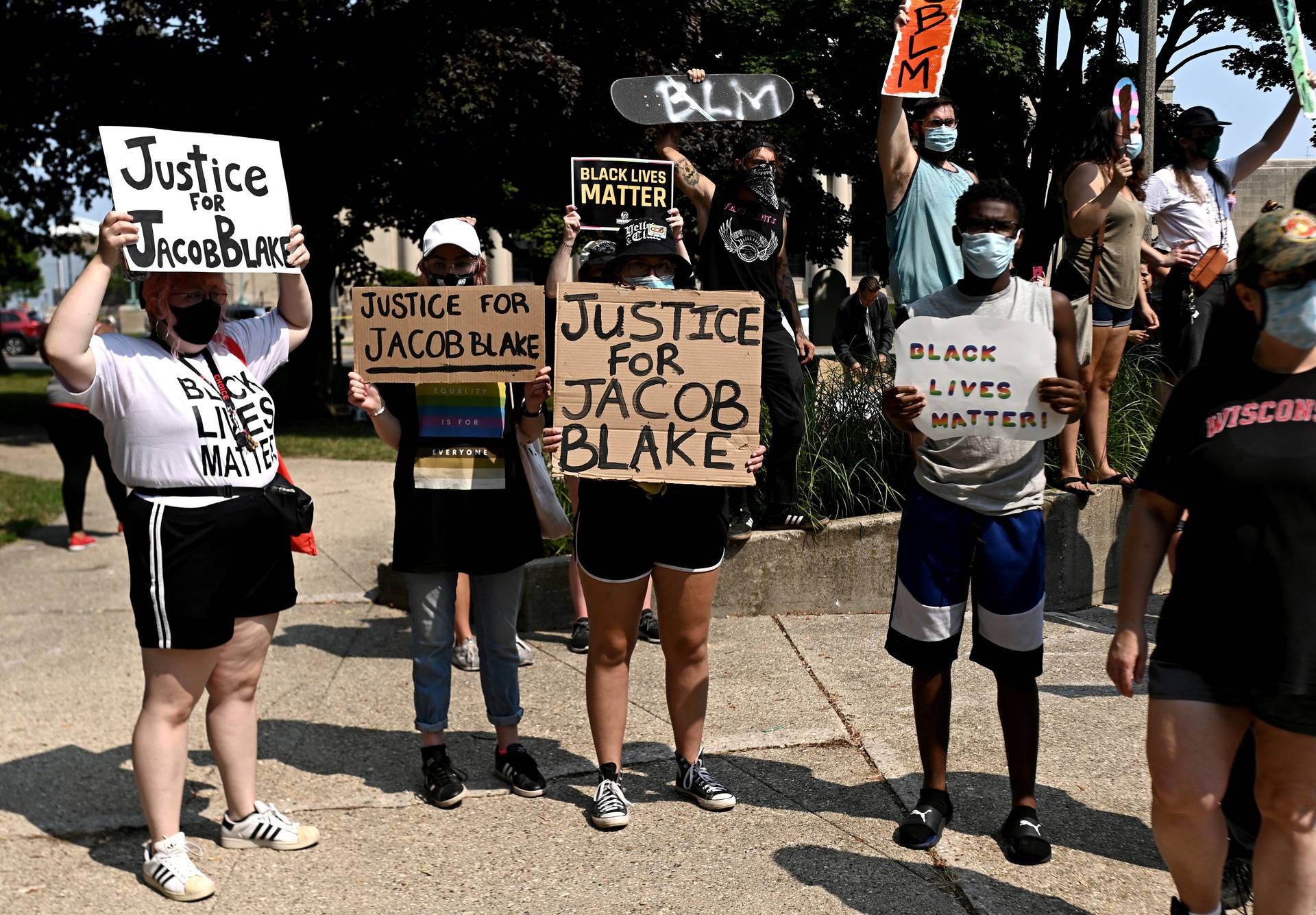 People protest after a Black man identified as Jacob Blake was shot several times by police in Kenosha
