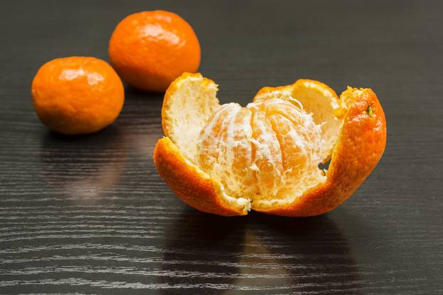 Removed peel from the ripe fruit of a sweet mandarin.