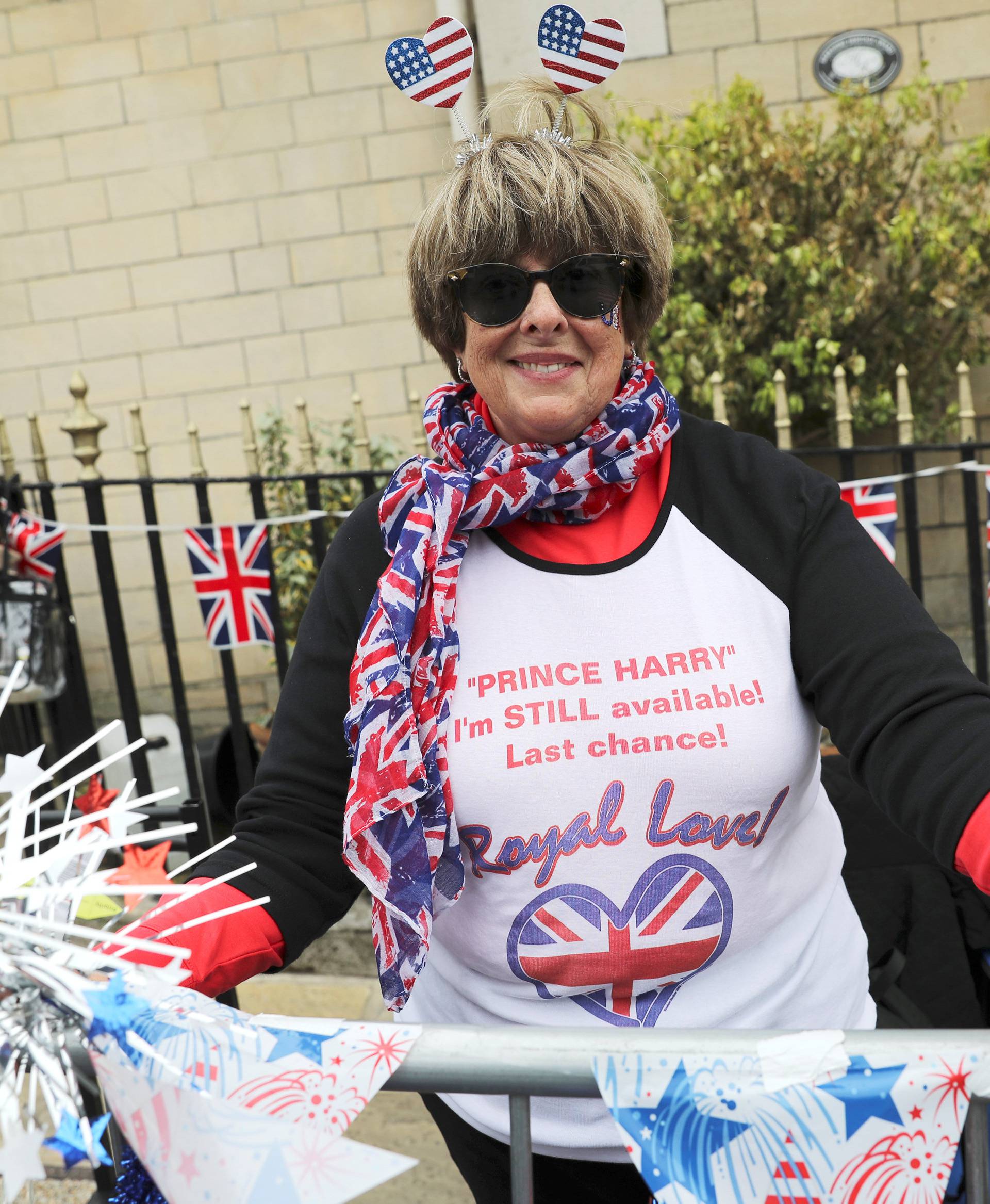 Donna Werner from the U.S., who is a super-fan of Britain's Royal Family, arranges flags and decorations near the spot she has chosen outside Windsor Castle from which to witness Prince Harry and Meghan Markle's carriage procession after their wedding, in