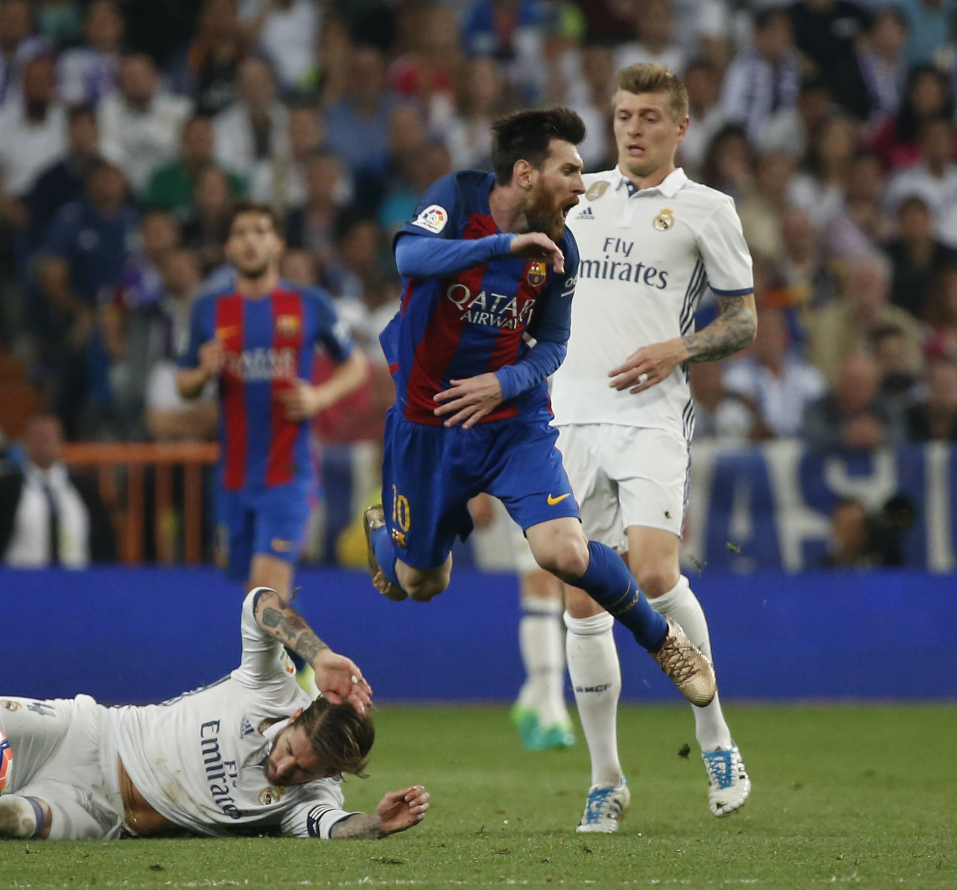 Real Madrid's Sergio Ramos is sent off after this challenge on Barcelona's Lionel Messi