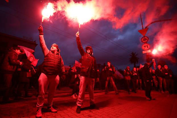 Protesters light flares and carry Polish flags during a rally, organised by far-right, nationalist groups, to mark 99th anniversary of Polish independence in Warsaw