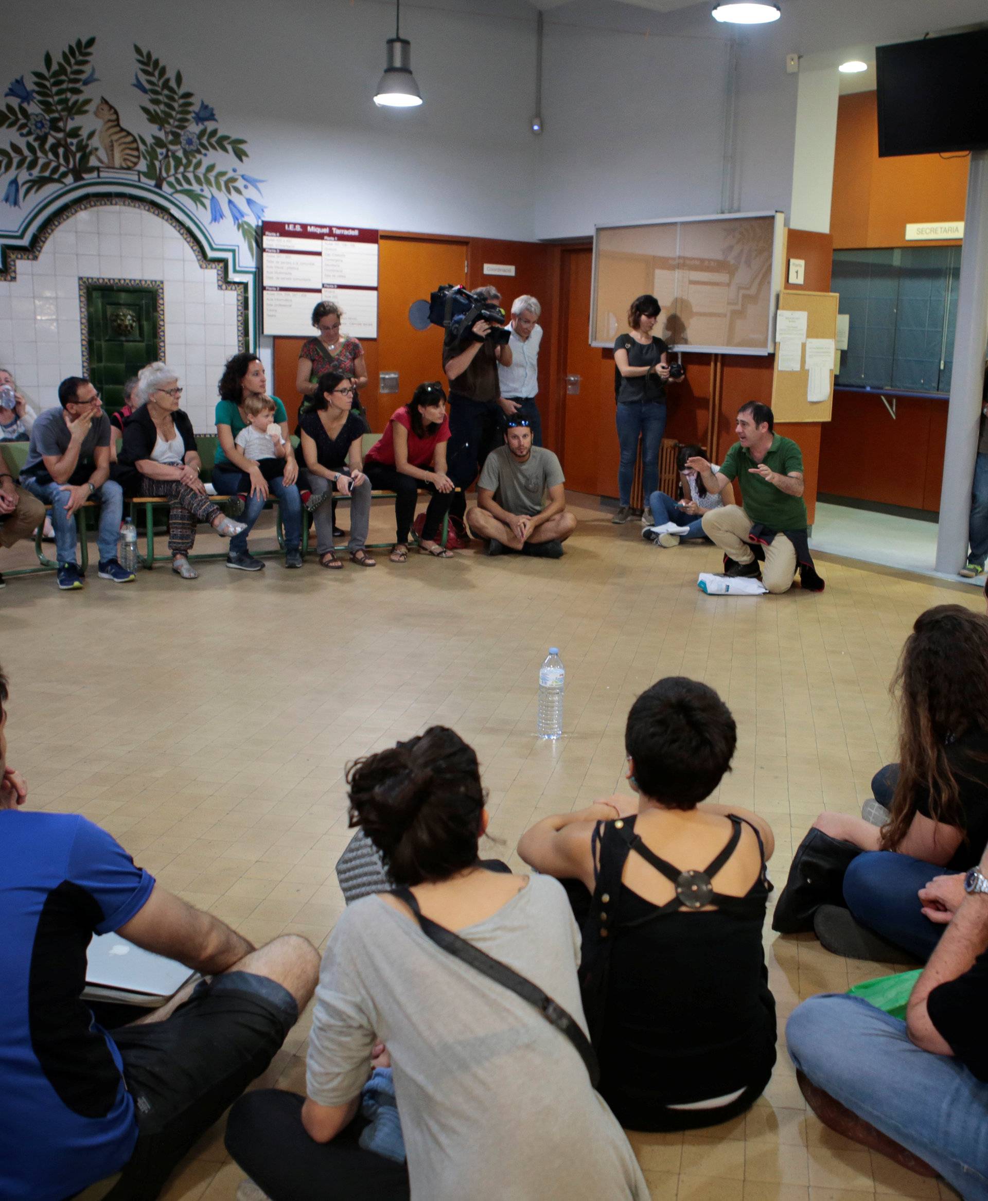 People gather in the Miquel Tarradell high school, one of the designated polling stations, to occupy the premises in a bid to permit voting in the banned independence referendum in Barcelona