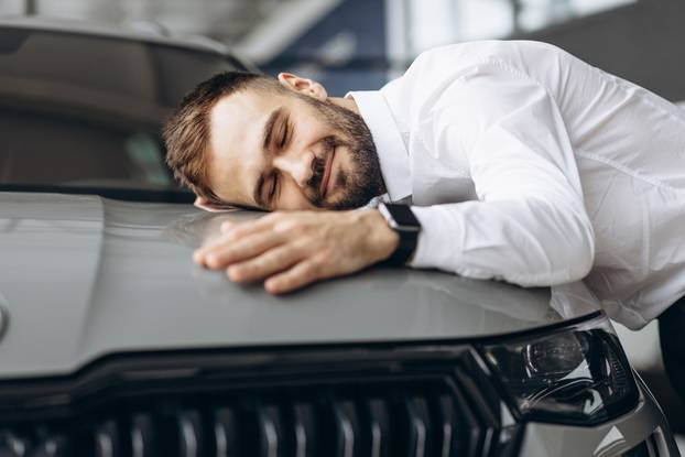 Man,Hugging,His,New,Car,In,Car,Showroom