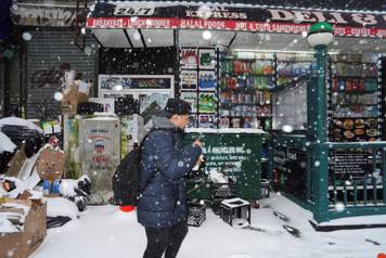 A pedestrian walks past Sal Express Deli & Grocery, in Brooklyn