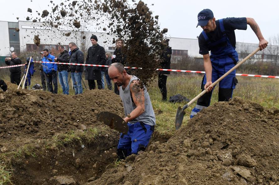 Gravediggers compete during a grave digging championship in Trencin, Slovakia