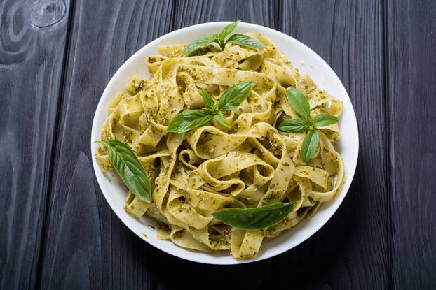 Pasta tagliatelle with green sauce pesto . Italian food backgrou
