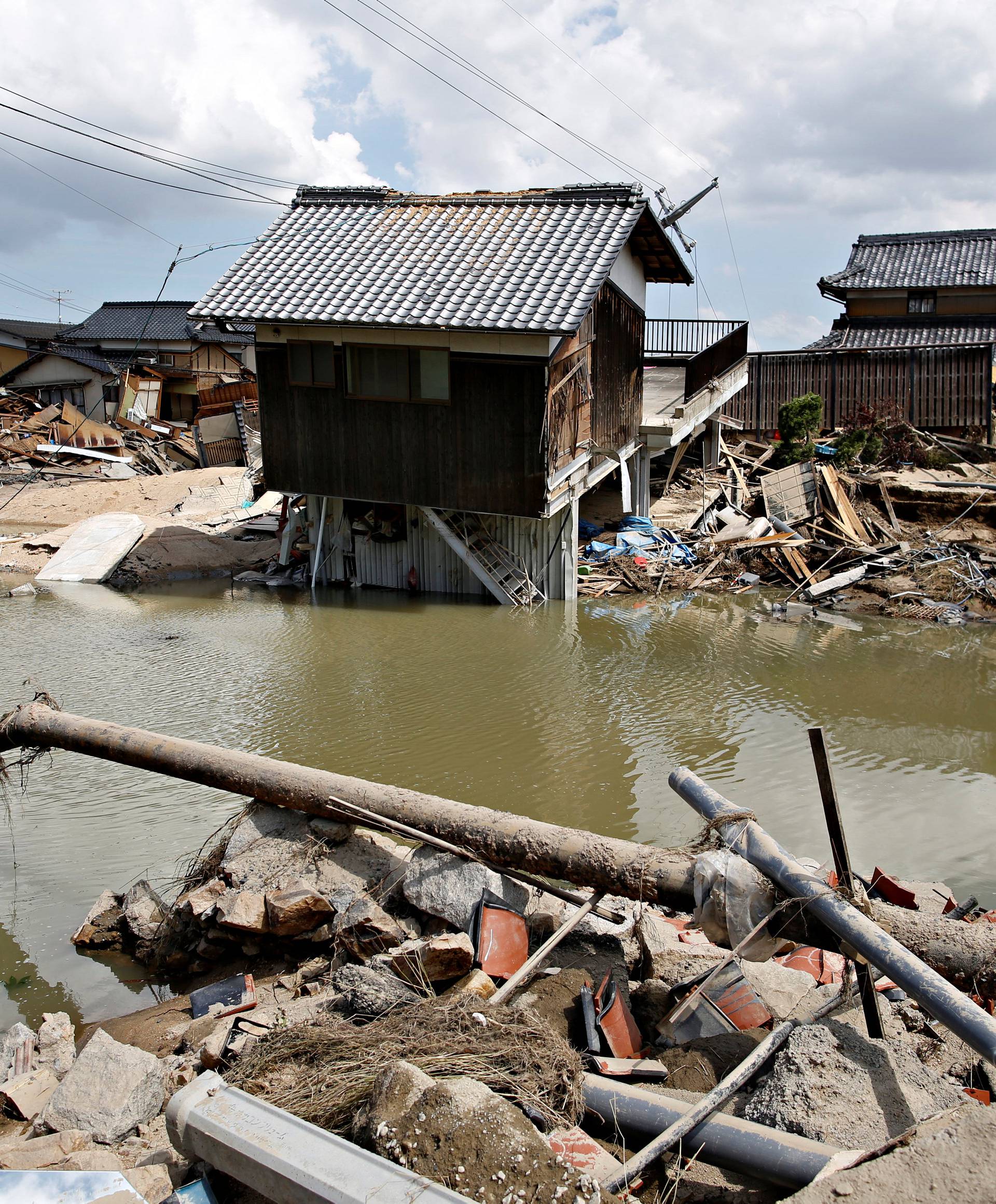 Submerged and destroyed houses are seen in a flooded area in Mabi town in Kurashiki