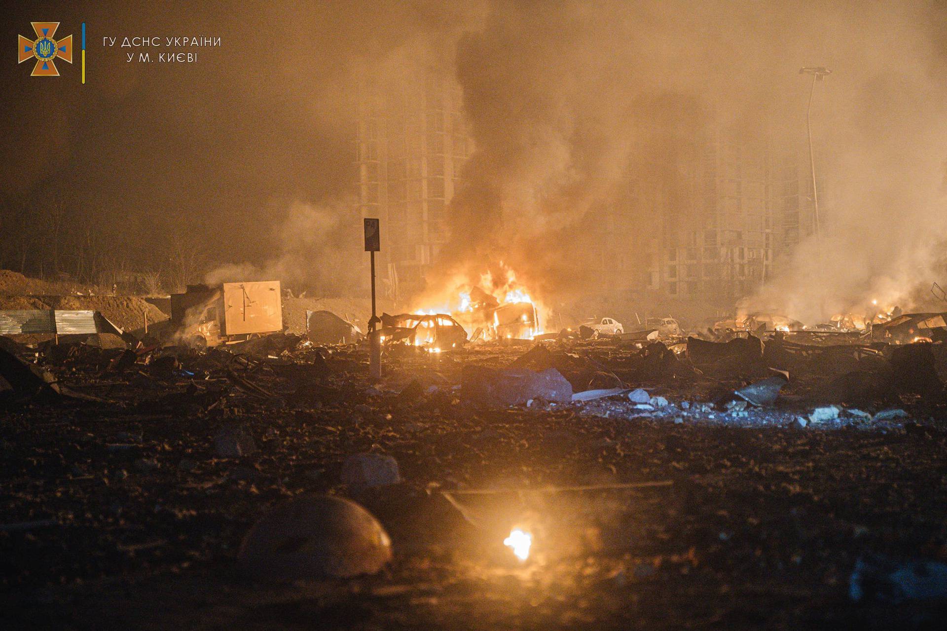 Damaged buildings and burned cars are seen after an airstrike in Kyiv