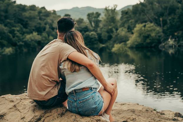 Young couple hugging in a natural lake