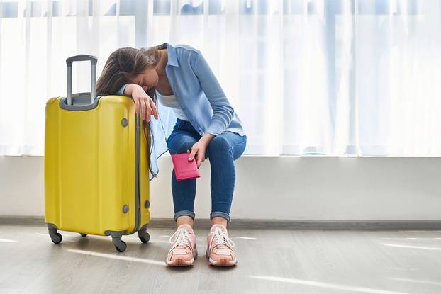 Woman,Traveler,With,Yellow,Suitcase,Affected,By,Flight,Delay,And