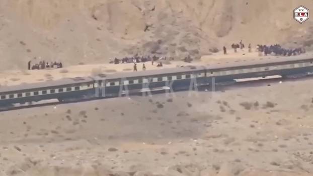 People gather outside a train during an attack by separatist militants near Mashkaf