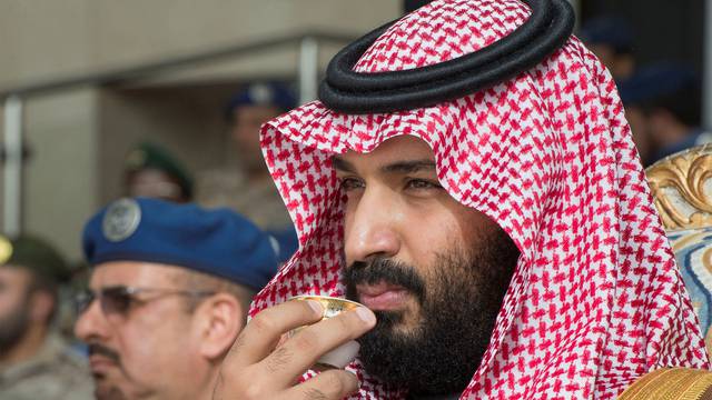 Saudi Arabia's Crown Prince Mohammed bin Salman drinks coffee during the graduation ceremony of the 93rd batch of the cadets of King Faisal Air Academy, in Riyadh