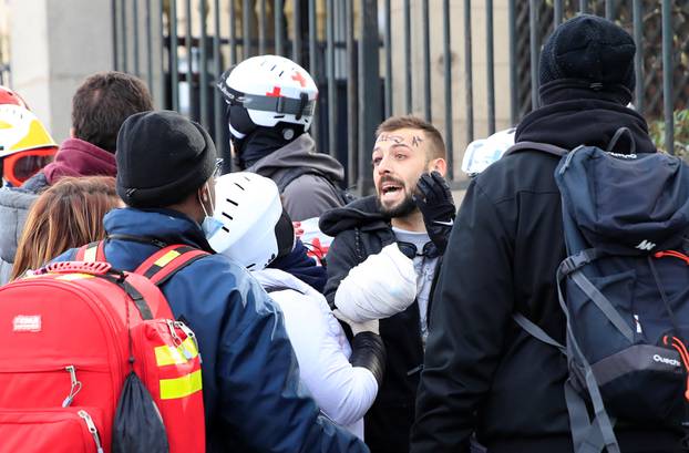 An injured protester is given help during a demonstration by the "yellow vests" movement in Paris