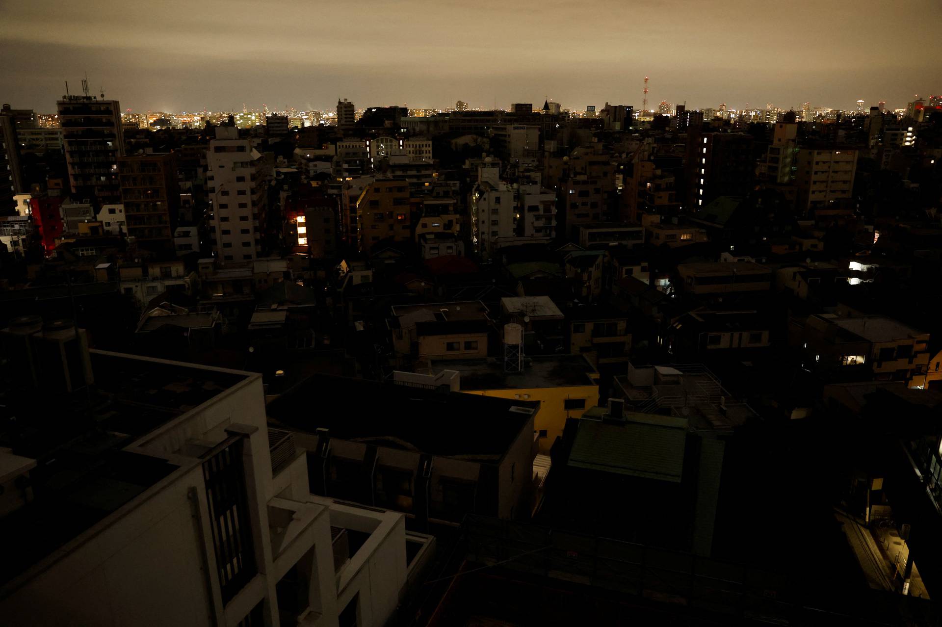 Houses and buildings are seen in an electric stoppage at the area after an earthquake at Toshima ward in Tokyo