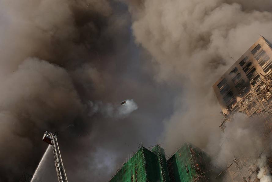 Flames engulf bamboo scaffolding across multiple buildings at Wang Fuk Court housing estate, in Tai Po