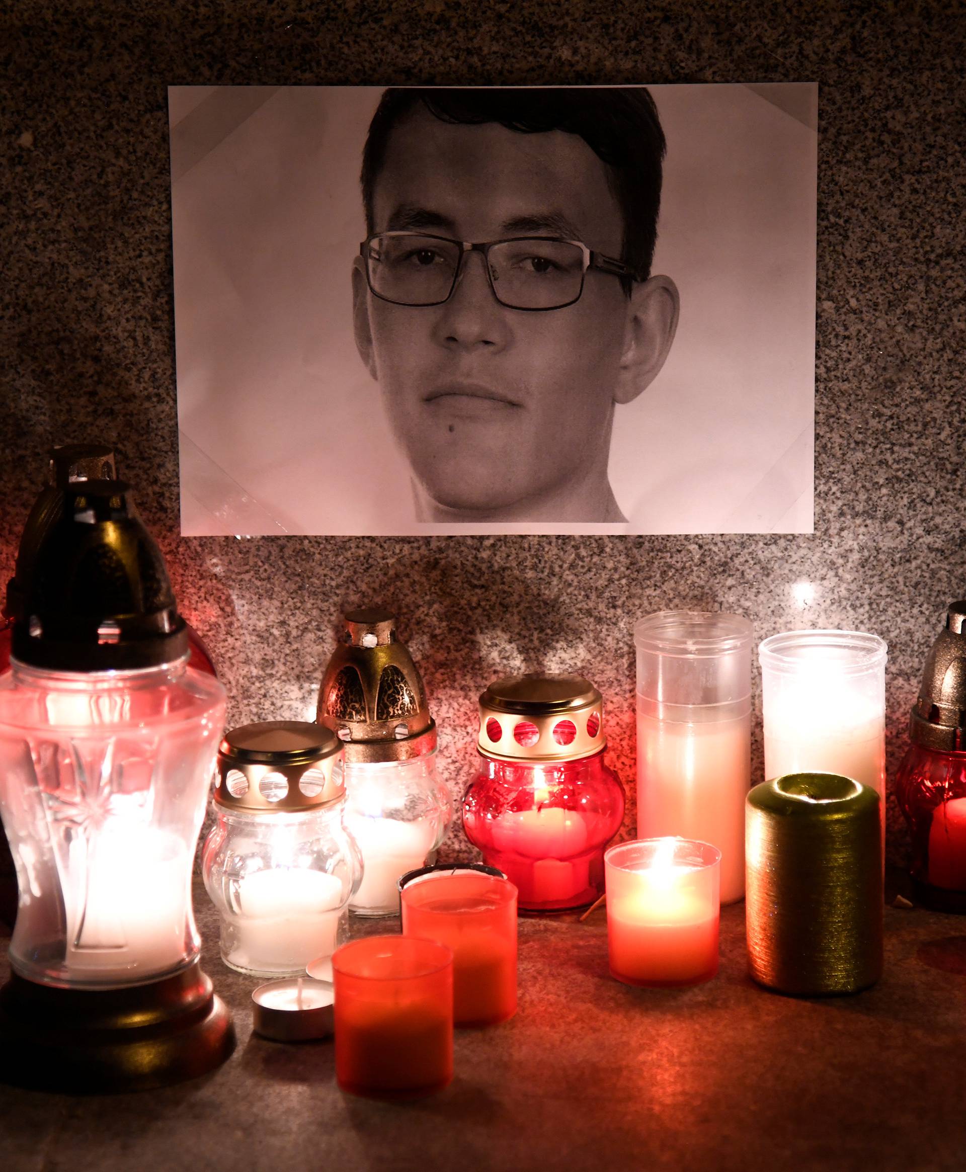 Candles in memory of murdered investigative journalist Jan Kuciak are seen in Trencin