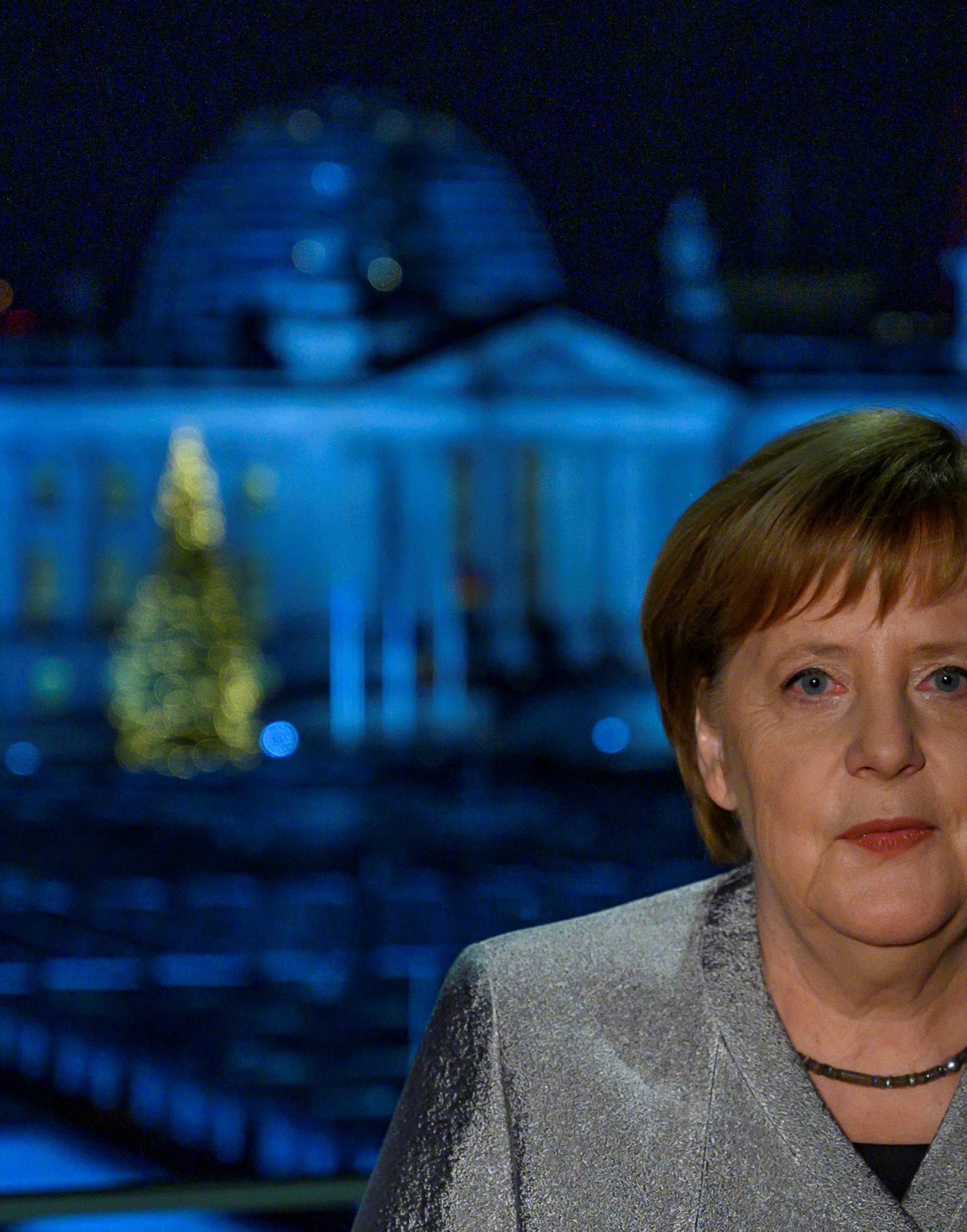 German Chancellor Angela Merkel poses for a photograph after the recording of her annual New Year's speech at the Chancellery in Berlin