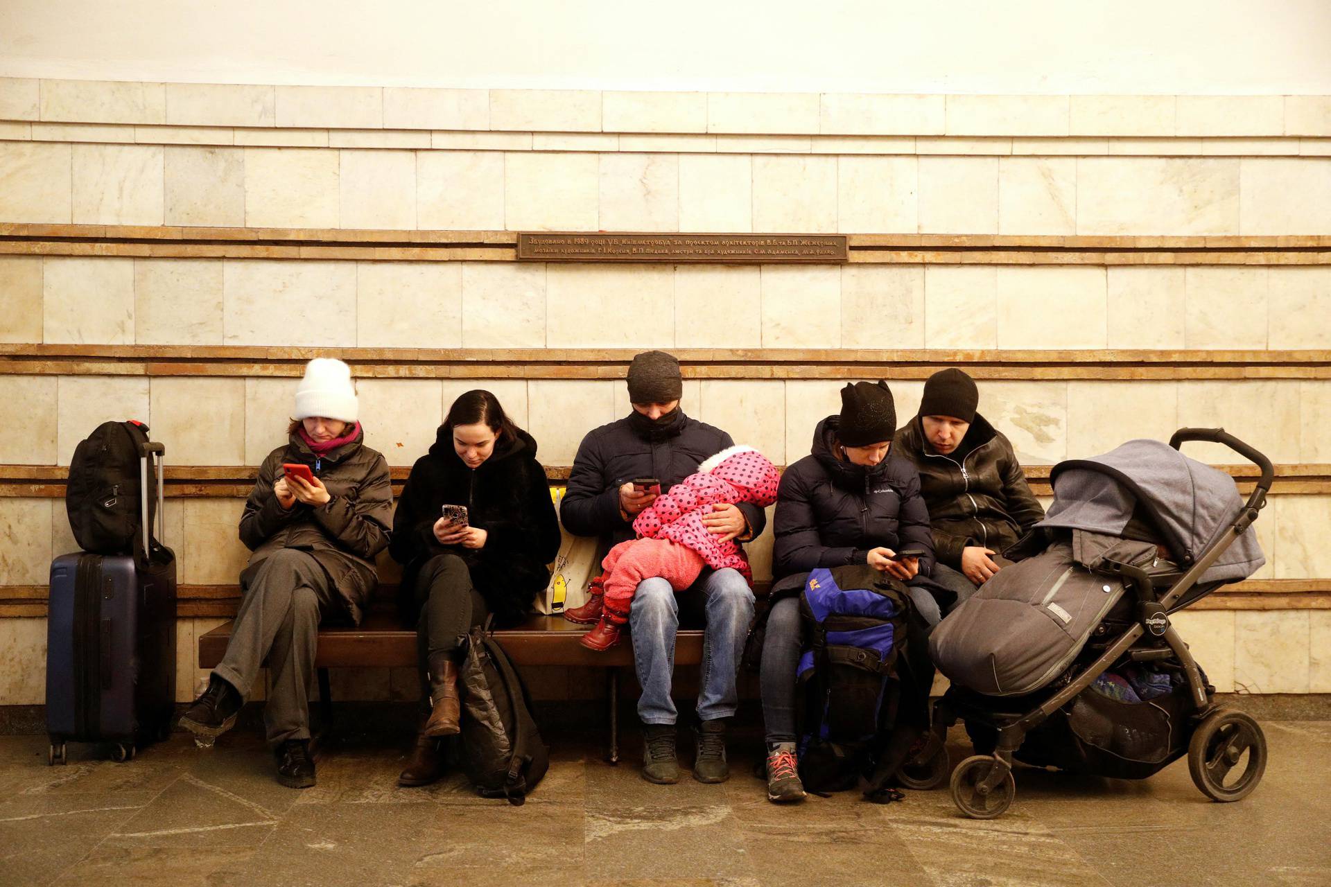 People take shelter in a subway station, after Russian President Vladimir Putin authorized a military operation in eastern Ukraine, in Kyiv