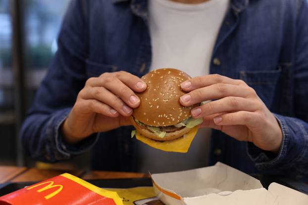 Lviv,,Ukraine,-,October,9,,2023:,Woman,With,Mcdonald's,Burger