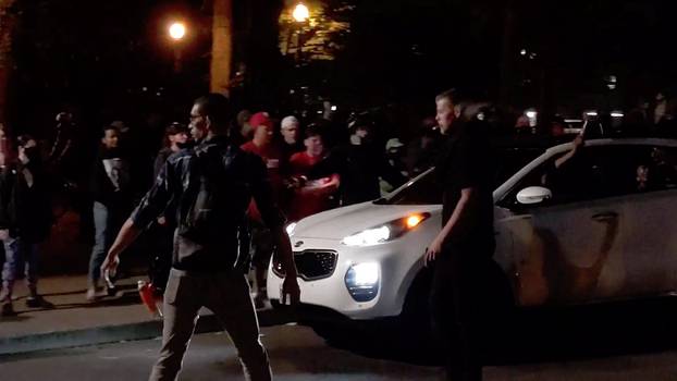 A driver fires a gun in the air near demonstrators during a Black Lives Matter protest in Portland, Oregon