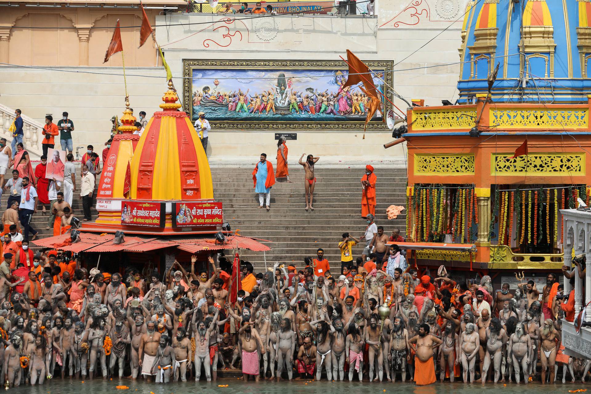 Naga Sadhus, or Hindu holy men, get ready to take a dip in the Ganges river during the second Shahi Snan at Kumbh Mela, in Haridwar