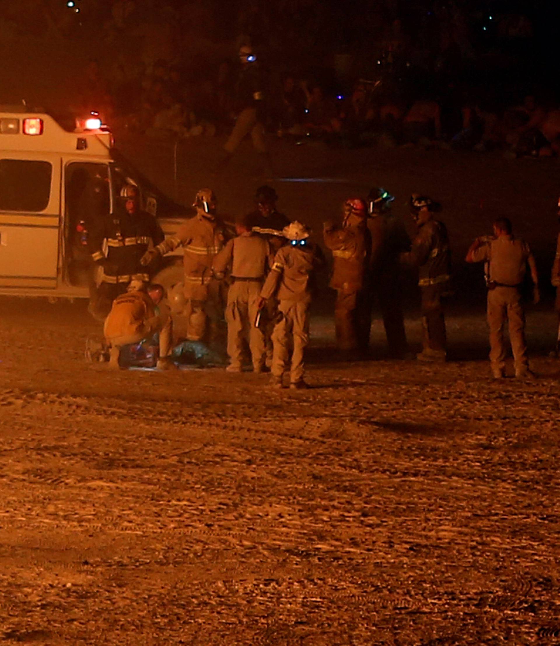 Emergency personnel respond to a participant that ran into the flames at the Man burn as approximately 70,000 people from all over the world gathered for the annual Burning Man arts and music festival in the Black Rock Desert of Nevada