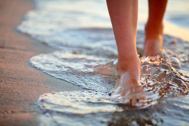 Female,Feet,Step,On,The,Sea,Wave.,Summer,Vacations,Concept