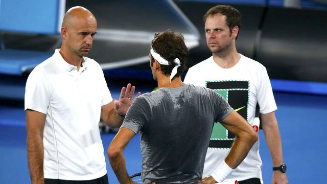 Switzerland's Roger Federer talks to his coaches Ivan Ljubicic and Severin Luthi during a training session ahead of the Australian Open tennis tournament in Melbourne