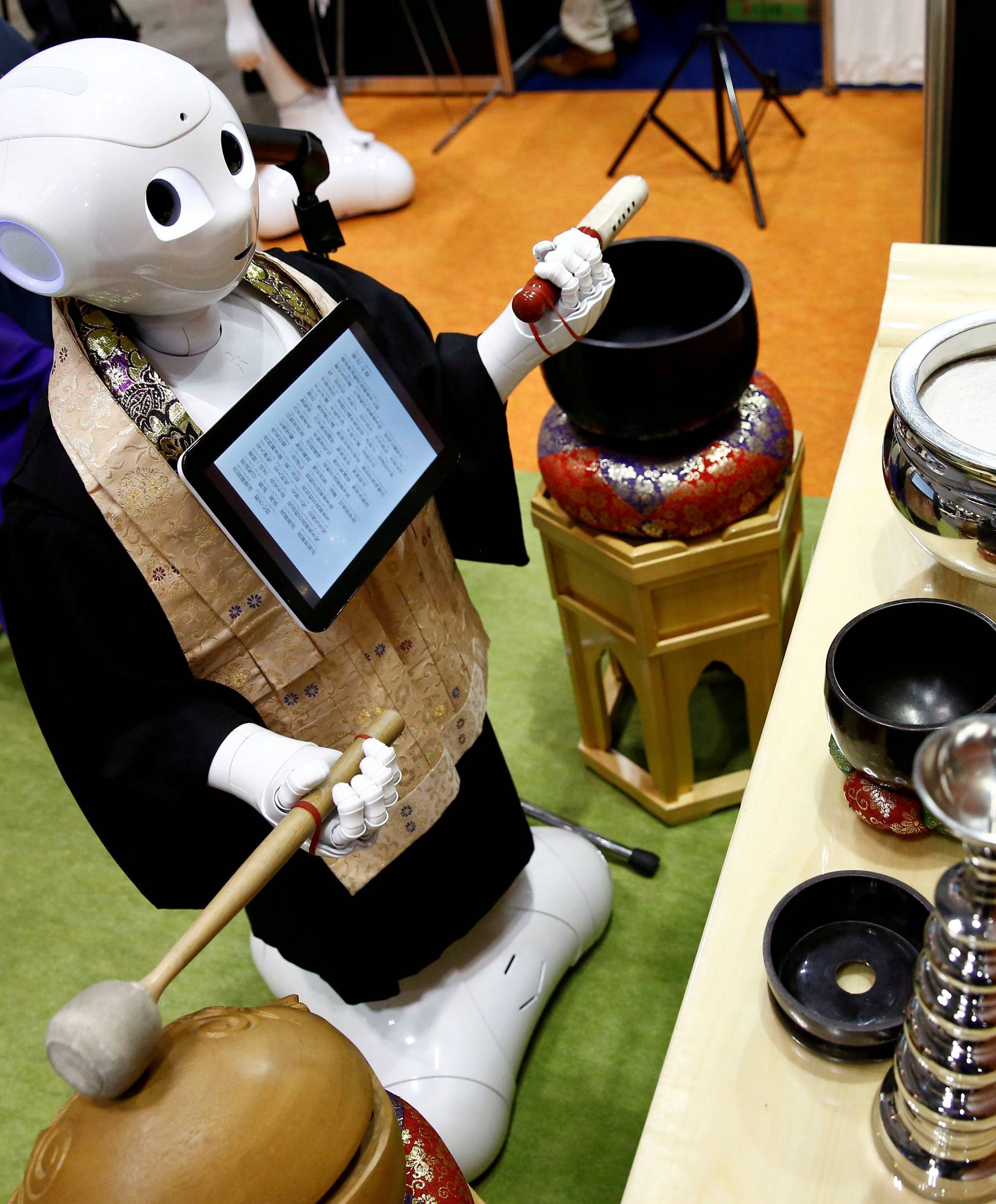 A 'robot priest' wearing a Buddhist robe chants sutras during its demonstration at Life Ending Industry EXPO 2017 in Tokyo