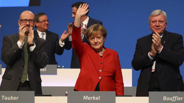 German Chancellor and leader of the conservative CDU Merkel waves after her speech at the CDU party convention in Essen